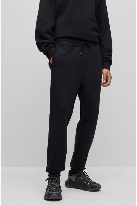 PANTALONES DE BUZO RELAXED FIT CON ESTAMPADO HOMBRE