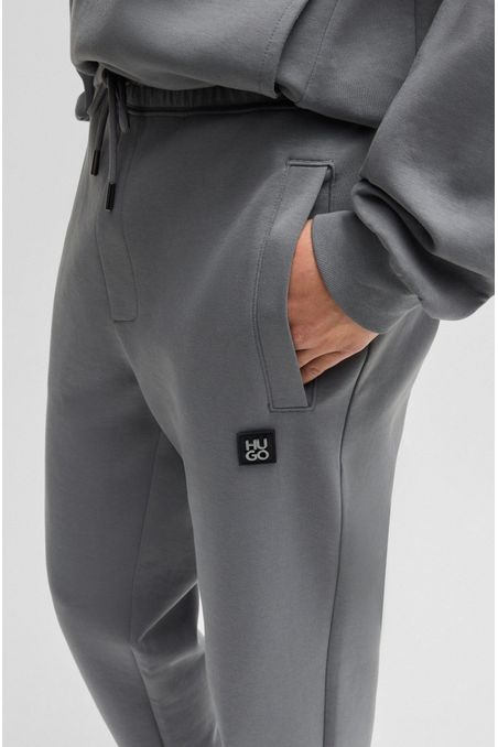 PANTALONES DE CHÁNDAL DE ALGODÓN CON LOGO APILADO PANTALONES RELAXED FIT HOMBRE
